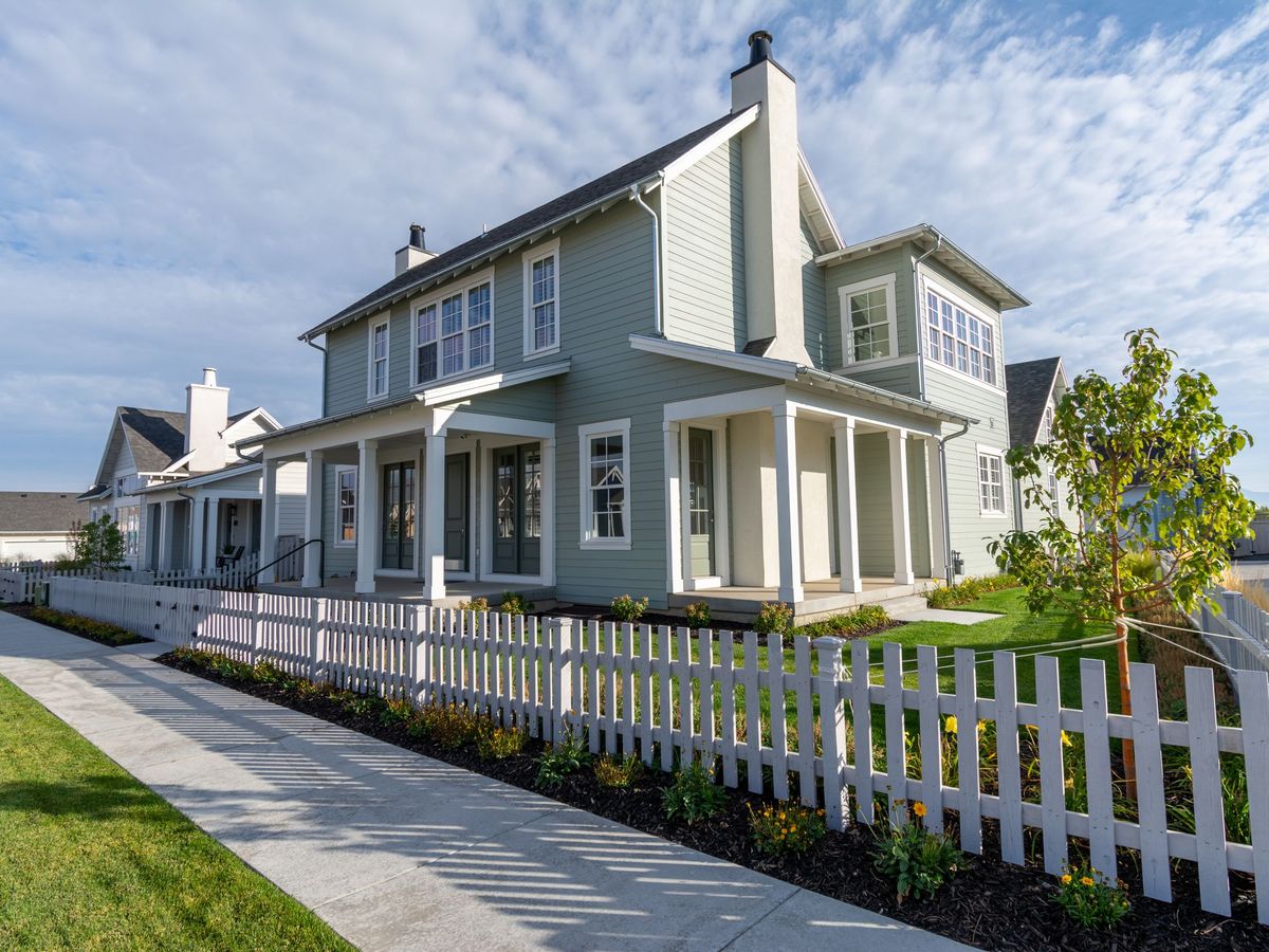 A residential street of single-family homes on a clear day
